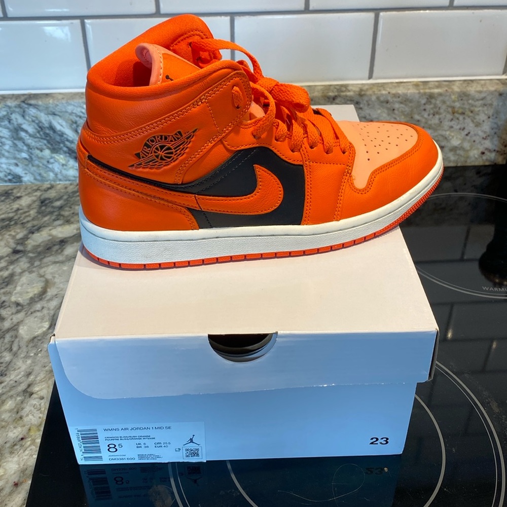 Women’s orange Jordan 1 Mid SE.